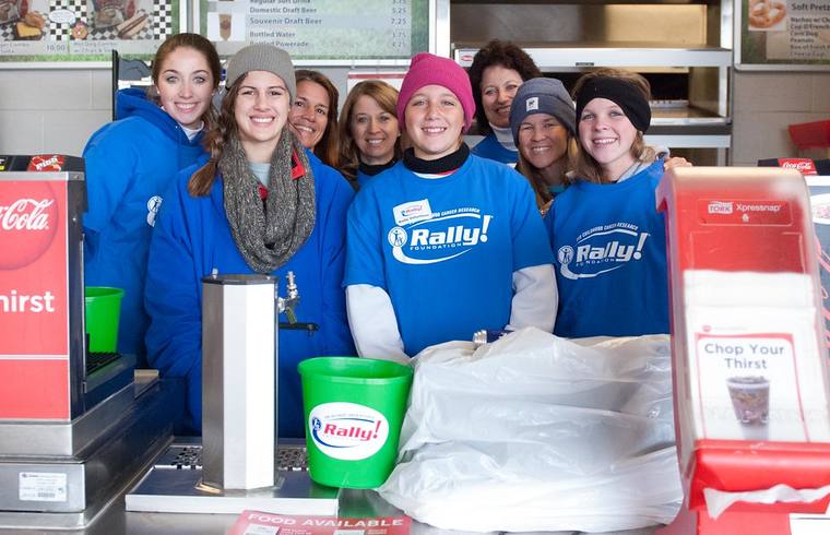 A group of Rally volunteers in blue Rally shirts working a concession stand